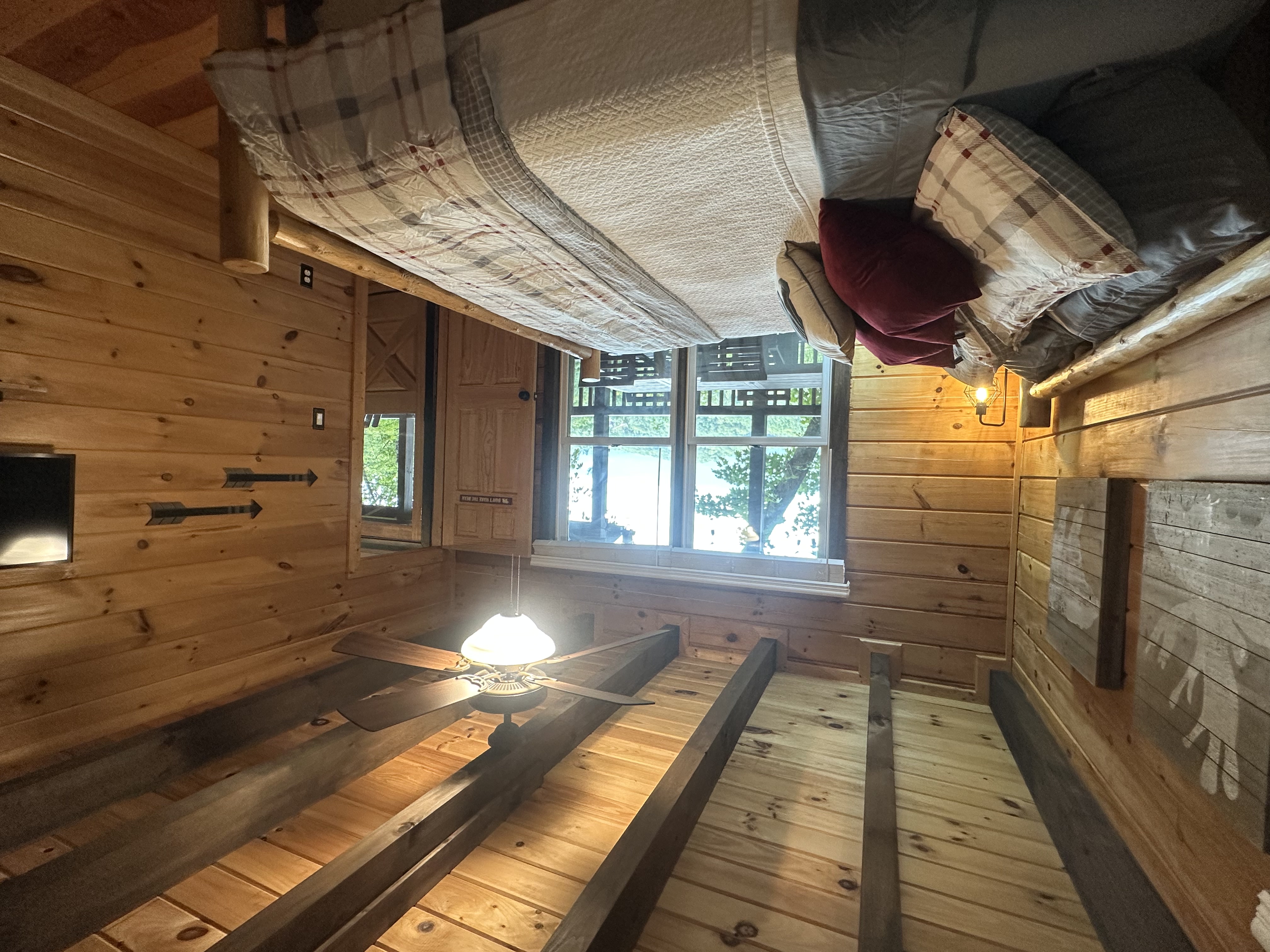 Main level bedroom with mountain charm and easy access to the heart of the cabin.